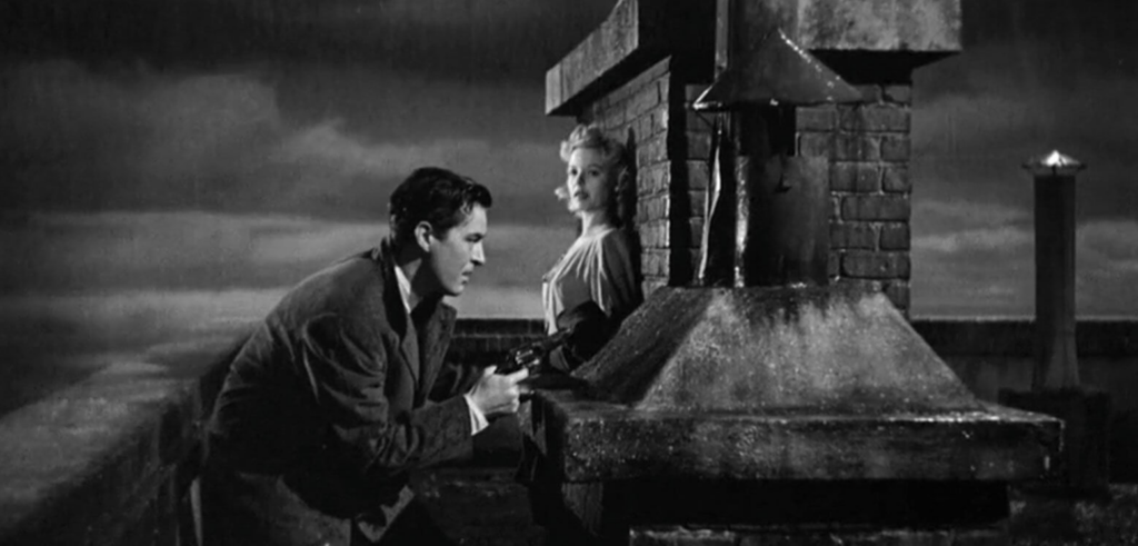 Ray Milland and Marjorie Reynolds sheltering behind a chimney